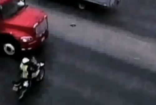 Video: Female bike cop survives shunt with articulated lorry