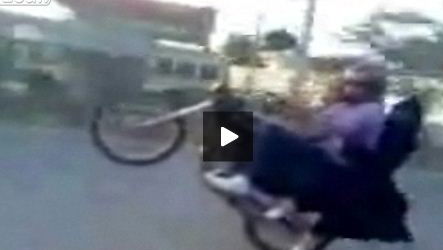 Video: Biker wheelies with burqa-wearing girlfriend clinging on
