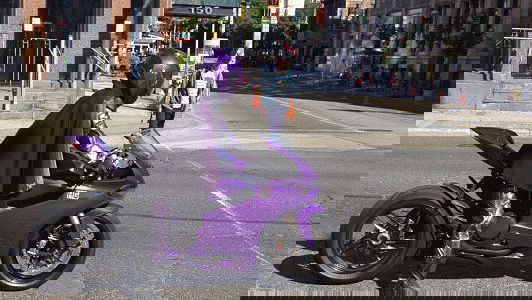 Hit Girl rides a purple Panigale