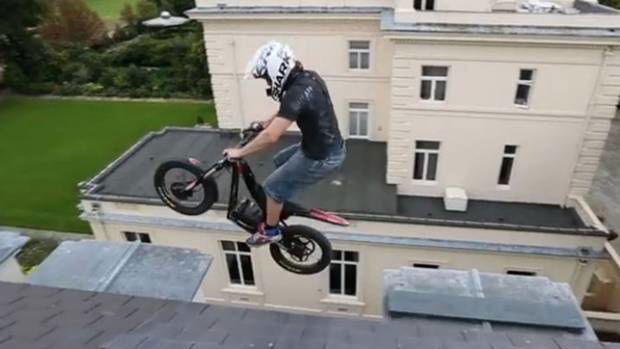 Daredevil biker jumps between roof ledges on £100m mansion