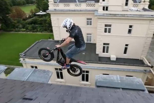 Daredevil biker jumps between roof ledges on £100m mansion