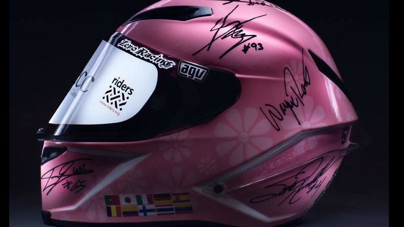 Helmet signed by GP legends makes £200,000 for charity