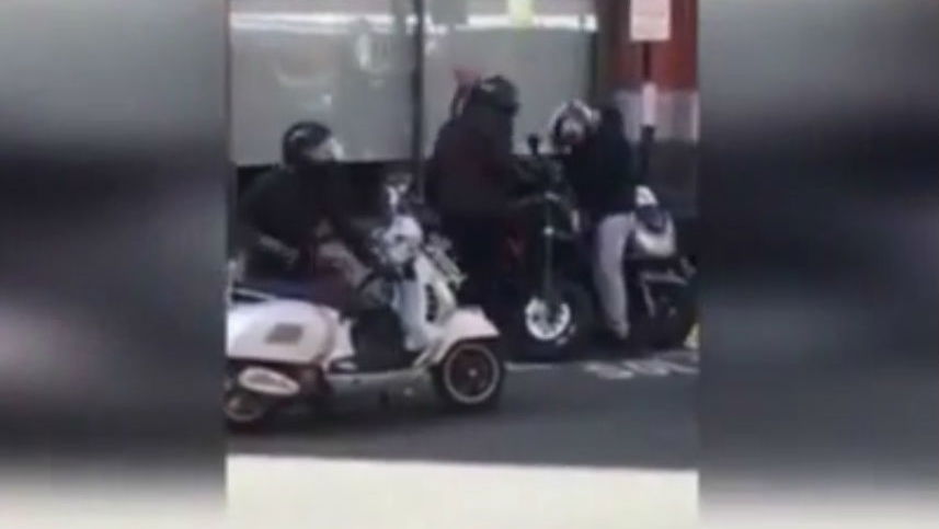 Motorcycle stolen in London as people stand and watch