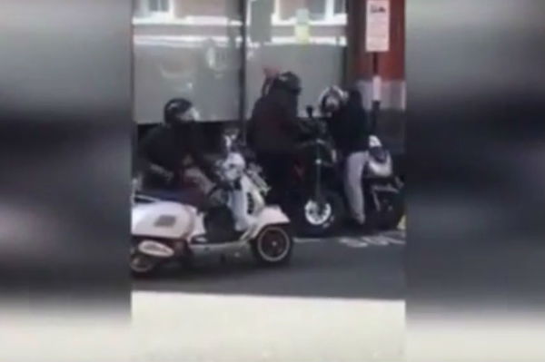 Motorcycle stolen in London as people stand and watch