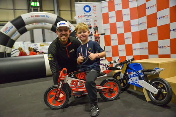 Peter Hickman and small blonde child on Kiddimoto bike