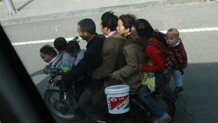 Caught on camera: EIGHT people on ONE motorcycle