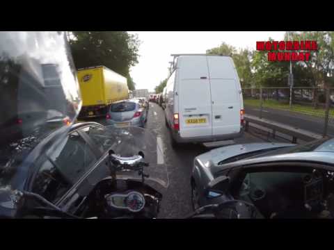 Car stuck in traffic appears to hit motorcyclist trying to get past - was it deliberate?