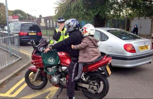 Here is how not to carry a child as a pillion - no safety gear (other than a helmet), and the footpegs are not even turned down!
