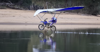 A moto hang glider crashing into a river