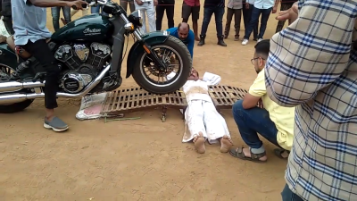 Pandit Dhayagude breaks 'being run over by motorcycles' world record. - Pandit Dhayagude/YouTube