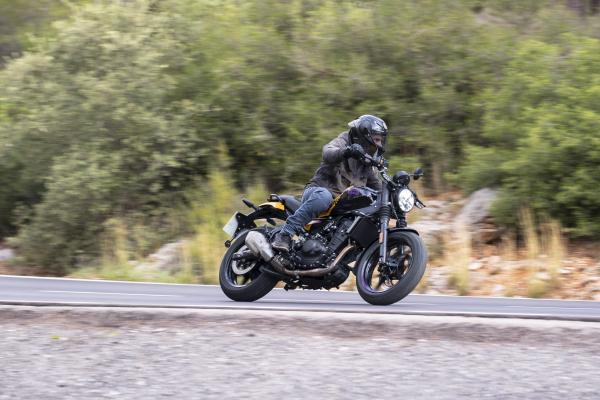 a motorcycle being ridden on a twisty road