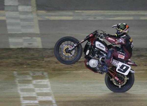 The Indian flat track bike pulling a wheelie