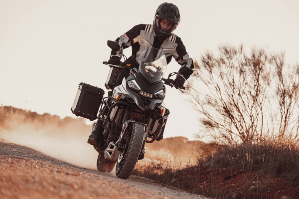 An adventure bike riding along a dirt track