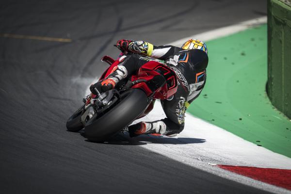 A rear view of a motorcycle being ridden through a bend