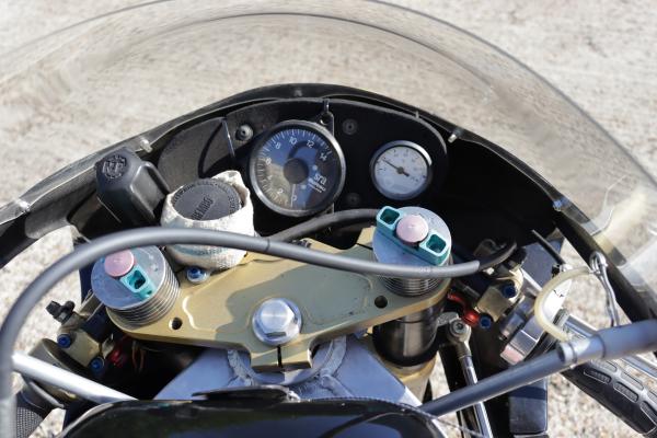 The cockpit of the bike showing the tacho and temperature guage