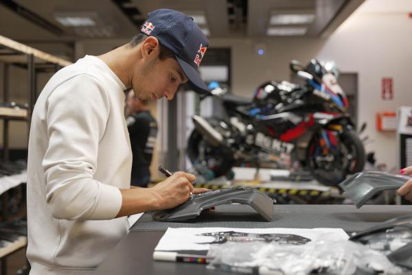 Toprak signing a piece of fairing