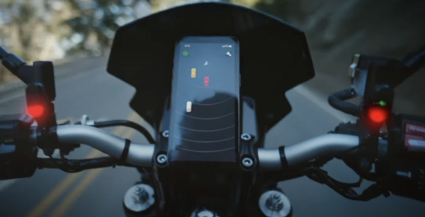 The Garmin Zumo R1 showing a vehicle in the rider's blindspot displayed on a Smartphone