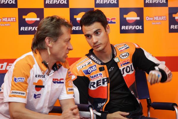 Mike Leitner discusses with Dani Pedrosa in Repsol Honda pit box, 2011 Italian Grand Prix. - Gold and Goose