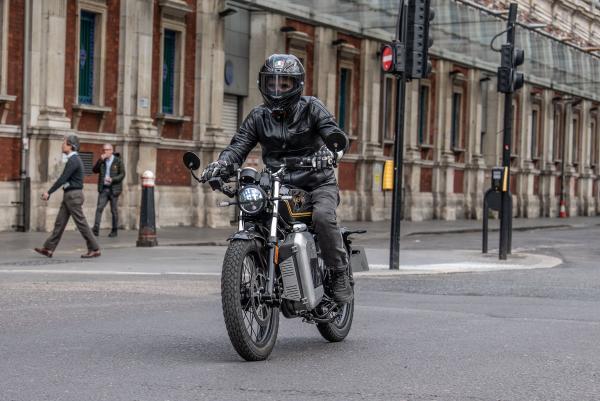 a motorbike riding past Smithfield Market in London