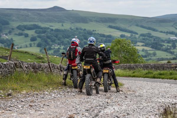 Three trail bike riders enjoying the view