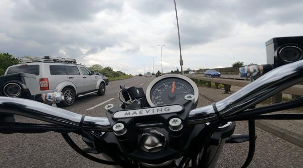 A motorcycle riding along a dual carriageway in the UK
