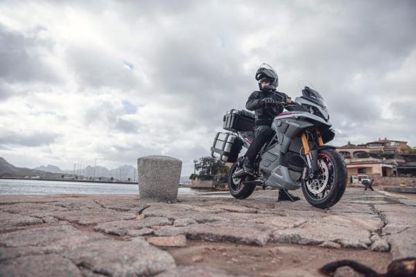 Experia electric sports touring motorcycle parked on some rocks