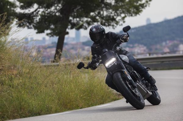 An electric motorcycle riding along a mountain road