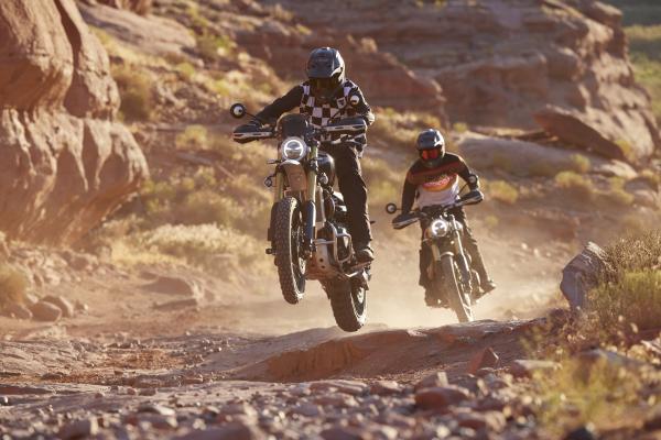 A Scrambler 1200 jumping through the air in the desert