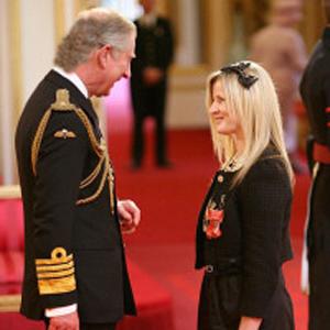 Costello takes taxibike to receive MBE