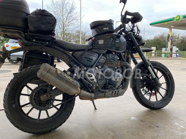 Triumph single-cylinder motorcycle at a petrol station