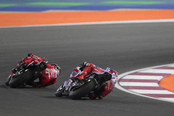 Fabio Di Giannantonio chases Francesco Bagnaia, 2023 MotoGP Qatar Grand Prix. - Gold and Goose