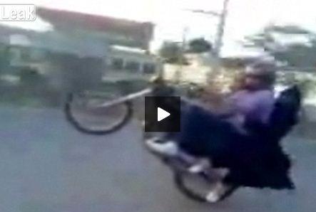 Video: Biker wheelies with burqa-wearing girlfriend clinging on