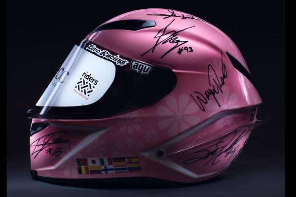 Helmet signed by GP legends makes £200,000 for charity