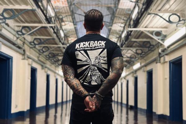 A biker in a prison while handcuffed