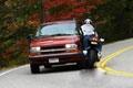 Biker runs wide and strikes car - photo sequence