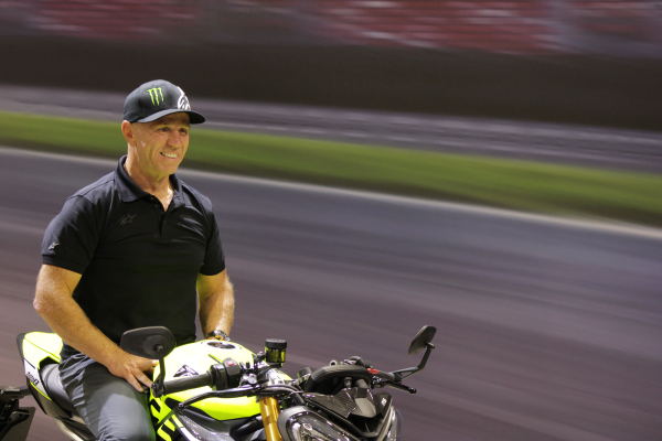 Randy Mamola sitting on Triumph Street Triple 765 Moto2 Edition at Motorcycle Live 2022.