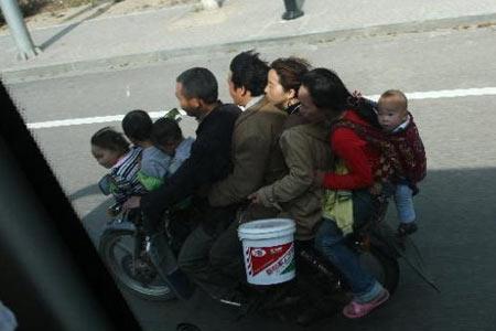 Caught on camera: EIGHT people on ONE motorcycle