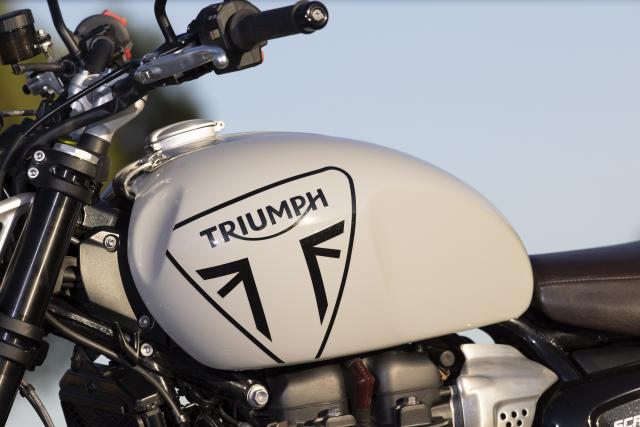 The fuel tank of a Triumph motorbike
