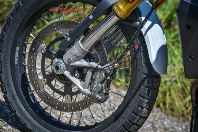 The front brake disc and calliper of a motorcycle
