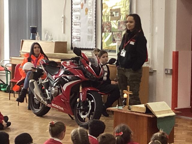 Sam giving a talk at Stanground St John's School for International Women's Day with Honda CBR500R