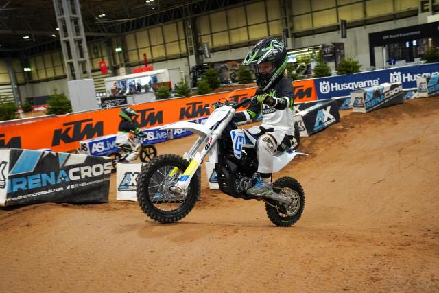 A young person riding a motocross bike