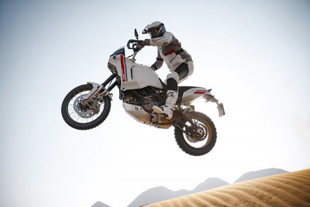 Ducati DesertX jumping through dunes
