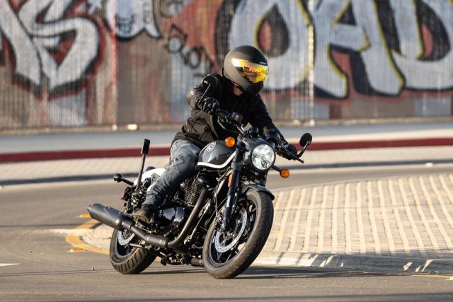 A motorcycle being ridden through an industrial area of LA