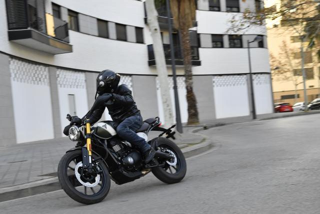 A motorbike being ridden in a city centre