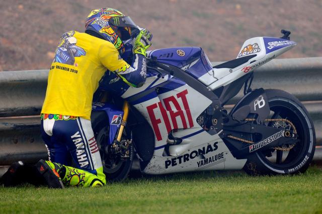 Valentino Rossi hugs Yamaha M1 after 2010 MotoGP Valencian Grand Prix. - Gold and Goose