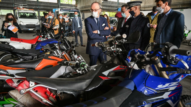 French officials looking at seized motorcycles. - France24/Philippe Desmazes/AFP