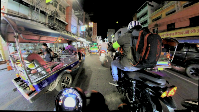 riding a motorcycle through Chinatown in Bangkok