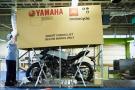 Yamaha motorcycle being placed in packaging for shipping.