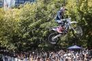 Billy Bolt jumps his Husqvarna enduro bike past a crowd of fans. - Red Bull Content Pool.