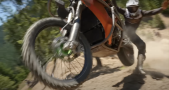 A rider falling off a Suzuki Hayabusa dirt bike